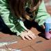 Carlee Spagnoli, 5, uses chalk to draw during the Promoting Ethnic And Cultural Equality Day on Sunday. Daniel Brenner I AnnArbor.com